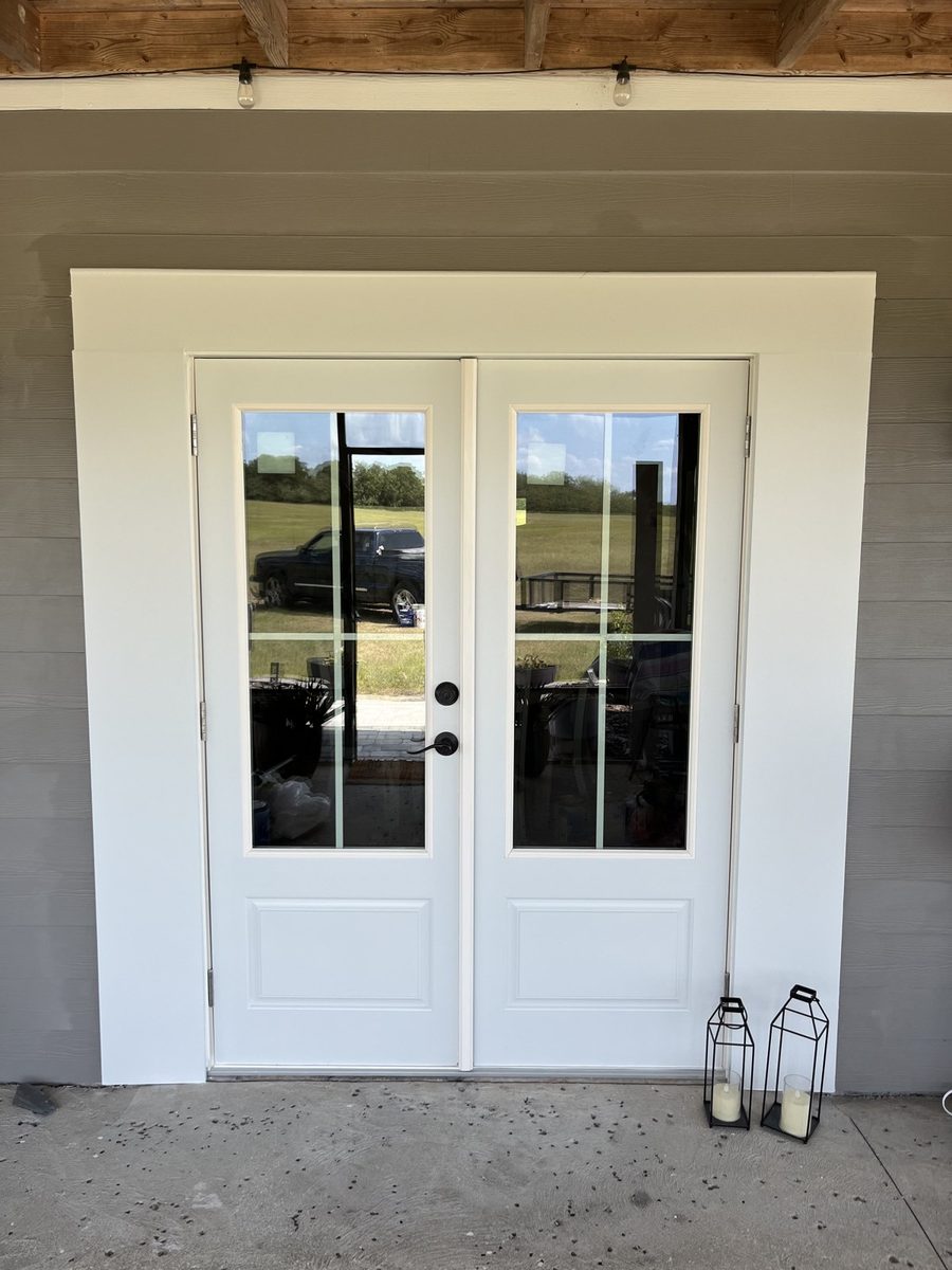 New white French doors installed in a block wall